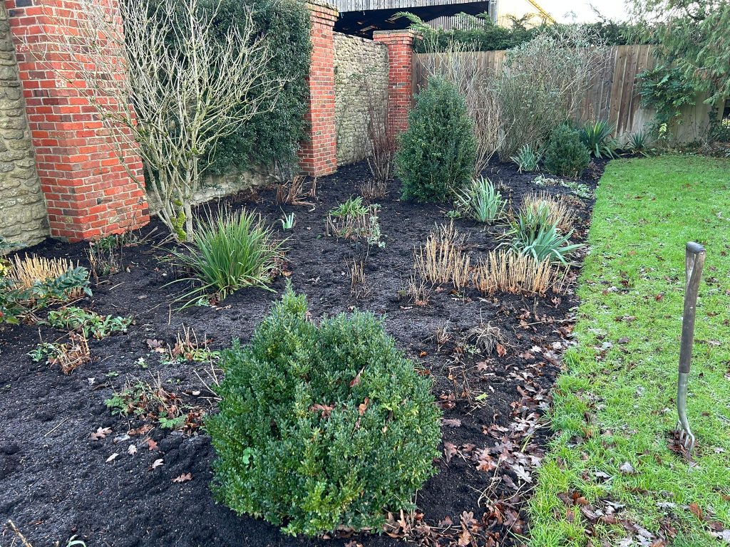 Mulch and compost added to garden beds