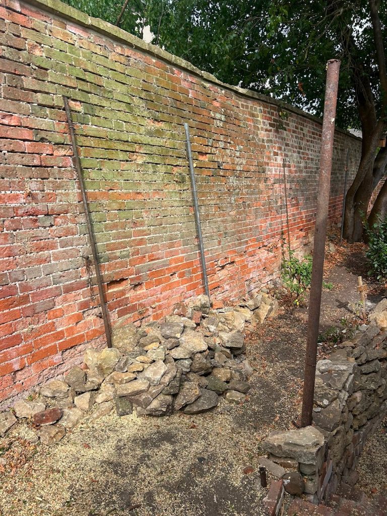 After picture of tidy wall where the shrub had once been